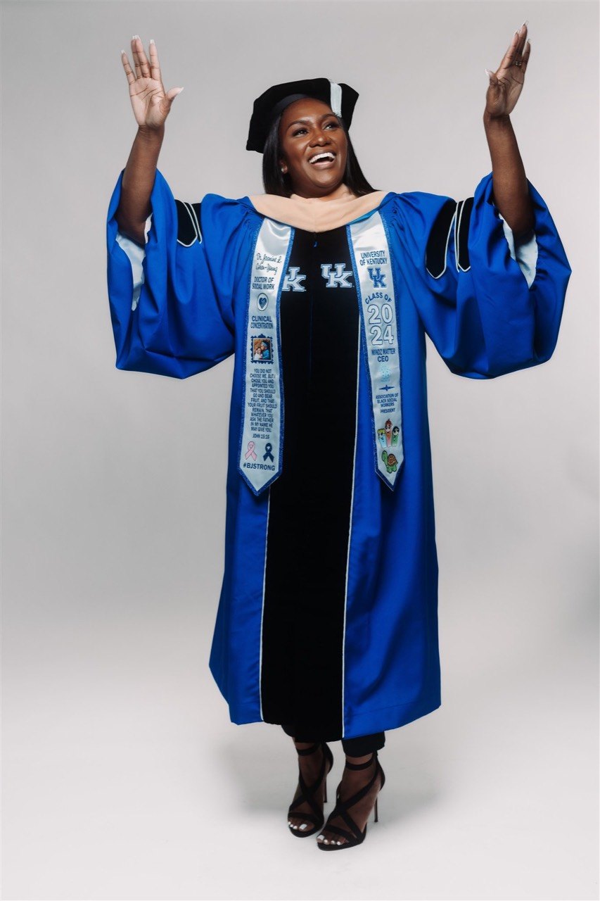Graduate celebrating in a blue doctoral gown